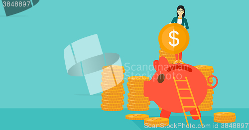 Image of Woman putting coin in piggy bank.