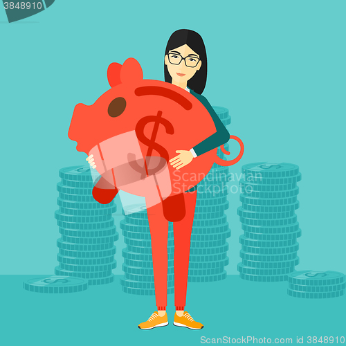 Image of Woman carrying piggy bank.