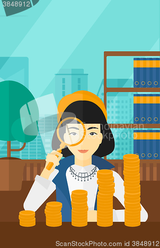 Image of Woman with magnifier and golden coins. 