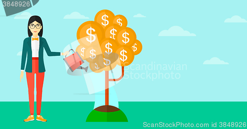 Image of Woman watering money tree.