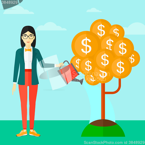 Image of Woman watering money tree.