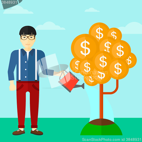 Image of Man watering money tree.