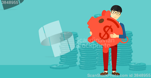 Image of Man carrying piggy bank.