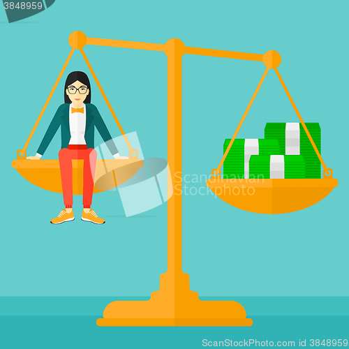 Image of Woman sitting on scale with coins.