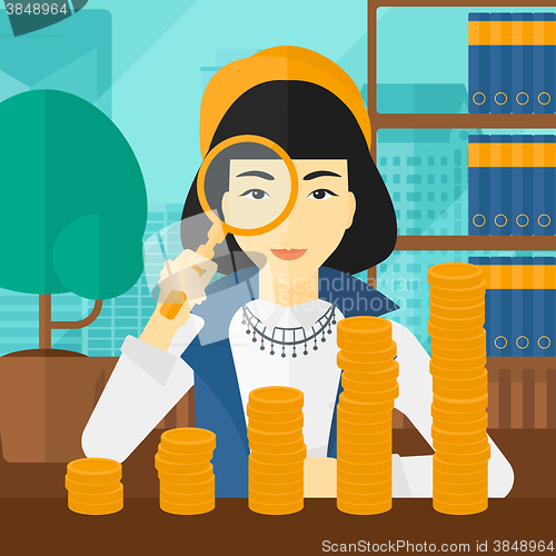 Image of Woman with magnifier and golden coins. 