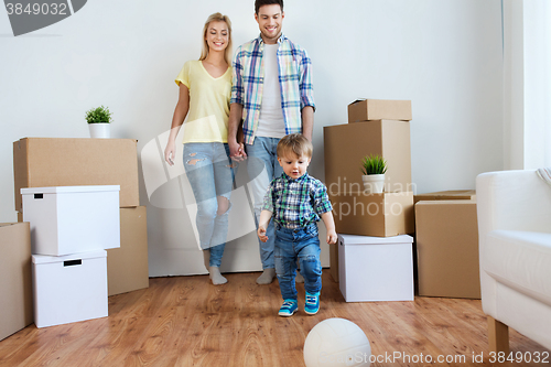 Image of happy family moving to new home and playing ball