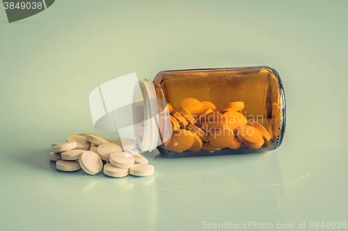Image of A glass of pills on a table