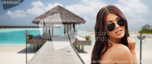 Image of young woman with sunglasses on beach