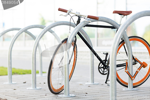 Image of close up of bicycle locked at street parking