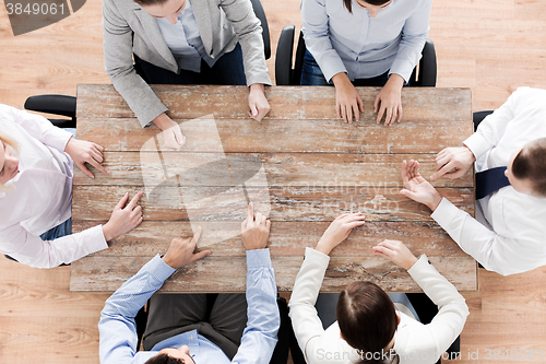 Image of close up of business team sitting at table