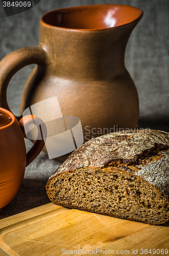 Image of Still life with homemade bread and pottery