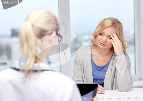 Image of doctor with tablet pc and ill woman at hospital