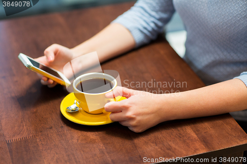 Image of close up of woman with smartphone and coffee