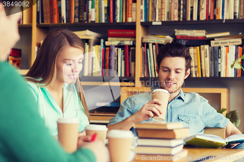 Image of students reading and drinking coffee in library