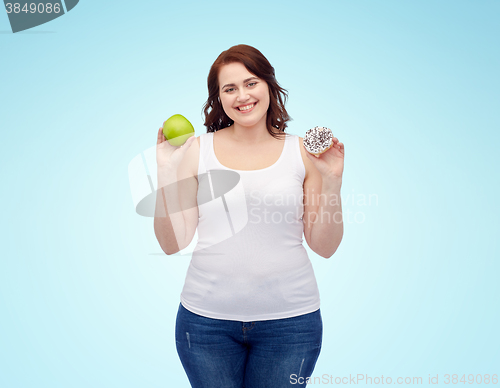 Image of happy plus size woman choosing apple or cookie