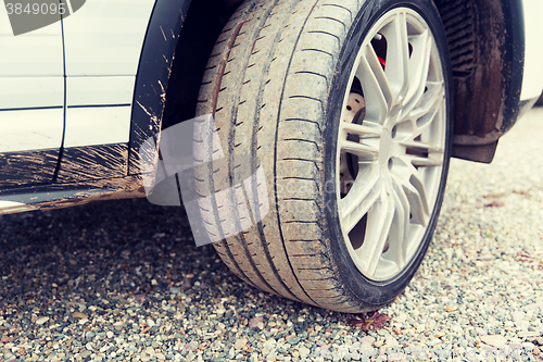 Image of close up of dirty car wheel on ground