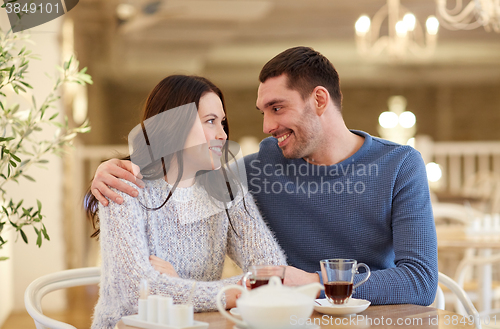 Image of happy couple drinking tea at restaurant