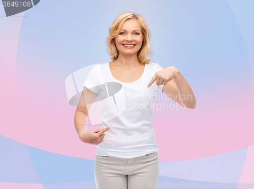 Image of smiling woman in white t-shirt pointing to herself