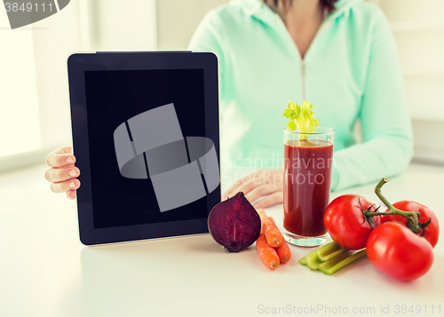 Image of close up of woman with tablet pc and vegetables