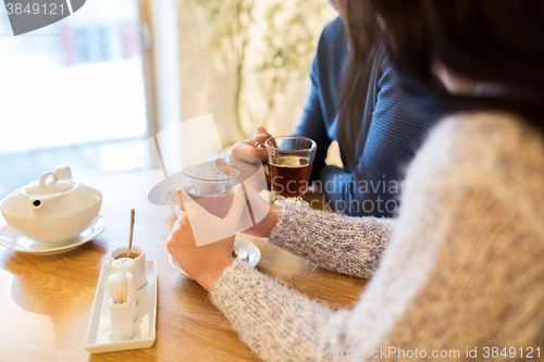 Image of close up of couple drinking tea at cafe