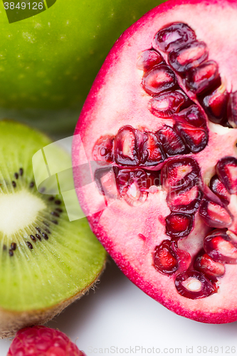 Image of close up of ripe pomegranate and kiwi
