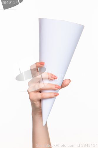 Image of The cone in female hands on white background