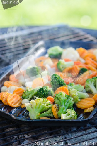 Image of Vegetables fried on coals, close up. Note: Shallow depth of fiel