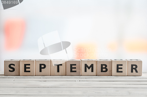 Image of September sign on a wooden table