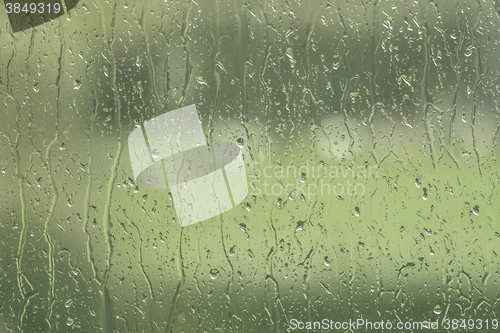 Image of Window with rain drops in green color
