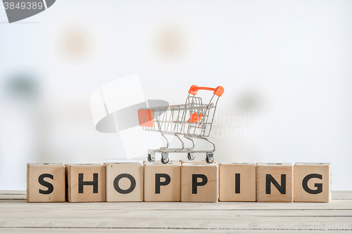 Image of Shopping cart on a wooden sign