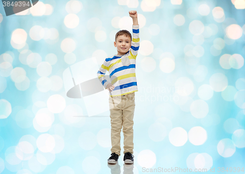 Image of happy smiling little boy with raised hand