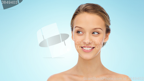 Image of smiling young woman face and shoulders