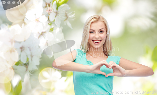 Image of happy woman or teen girl showing heart shape sigh