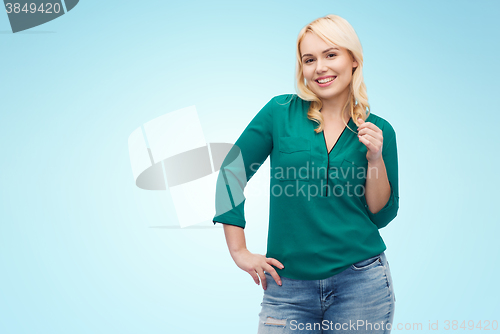 Image of smiling young woman in shirt and jeans