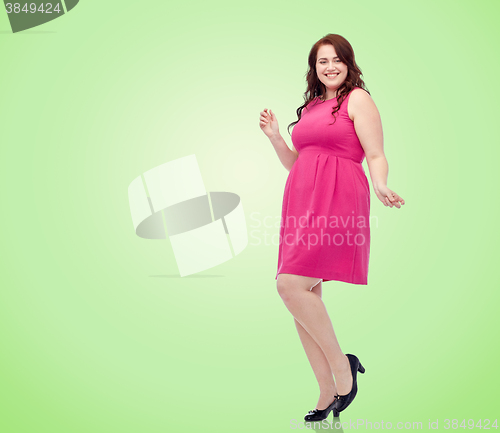 Image of happy young plus size woman dancing in pink dress