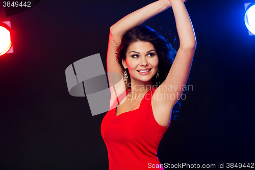 Image of beautiful sexy woman in red dancing at nightclub