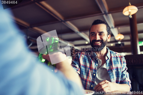 Image of happy male friends drinking beer at bar or pub