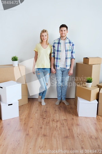 Image of smiling couple with big boxes moving to new home
