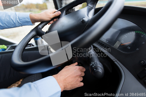 Image of close up of driver starting bus