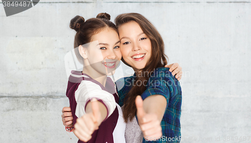 Image of happy smiling teenage girls showing thumbs up