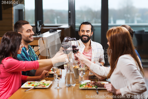 Image of friends dining and drinking wine at restaurant