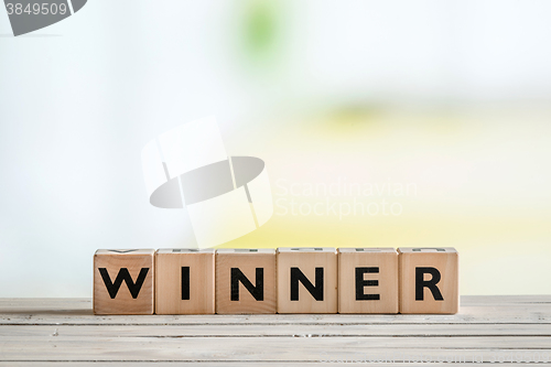 Image of Winner sign on a wooden desk