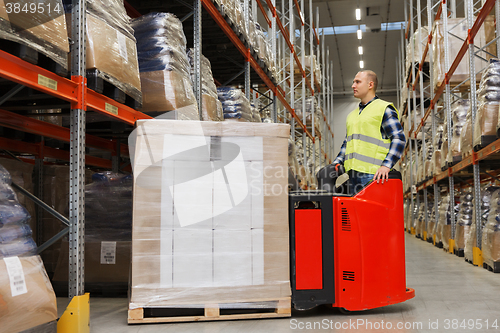 Image of man on forklift loading cargo at warehouse