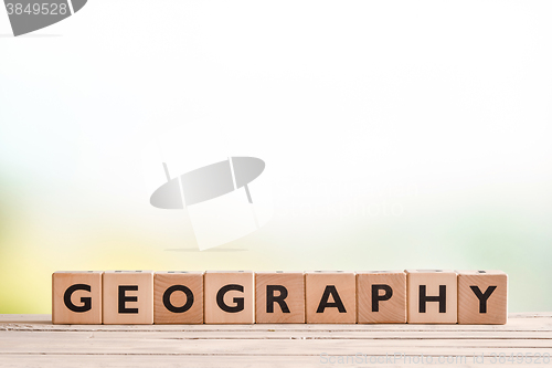 Image of Geography lesson sign on a wooden desk