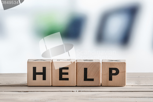 Image of Help sign on a wooden table