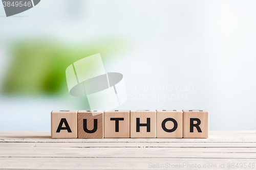 Image of Author sign on a wooden desk