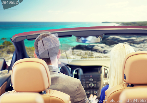 Image of couple driving in cabriolet car over sea shore