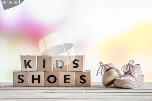 Image of Kids shoes on a wooden desk