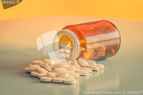 Image of Pills and a glass on a table