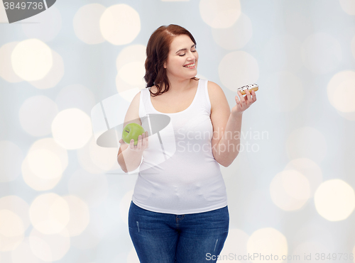 Image of happy plus size woman choosing apple or donut